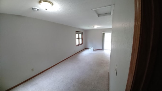 7047 Kingfisher Ln NE, Frohn Twp, MN 56601 - spare room with attic access, light carpet, and baseboards