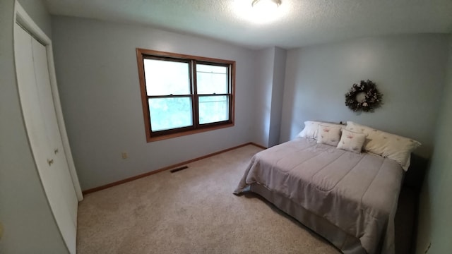 7047 Kingfisher Ln NE, Frohn Twp, MN 56601 - carpeted bedroom with a textured ceiling, a closet, and baseboards