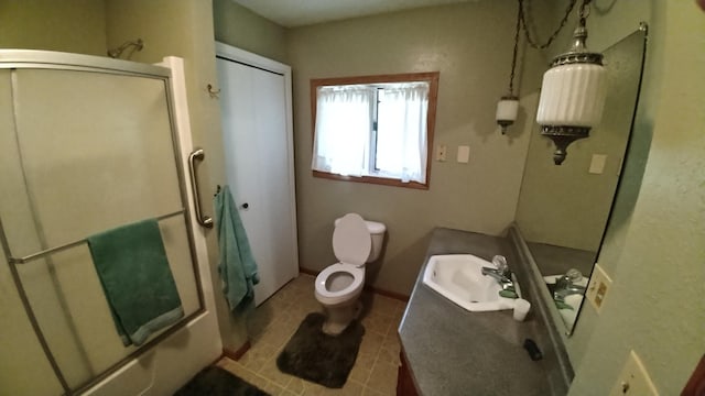 7047 Kingfisher Ln NE, Frohn Twp, MN 56601 - full bath featuring a shower with shower door, vanity, toilet, and tile patterned floors