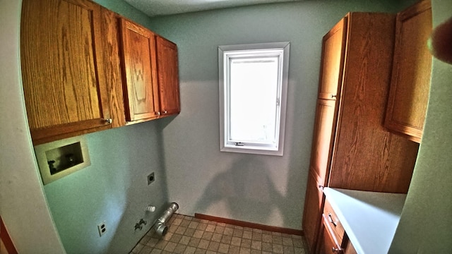 7047 Kingfisher Ln NE, Frohn Twp, MN 56601 - laundry area featuring electric dryer hookup, cabinet space, hookup for a washing machine, gas dryer hookup, and baseboards