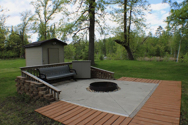7047 Kingfisher Ln NE, Frohn Twp, MN 56601 - wooden terrace featuring an outdoor fire pit and a lawn