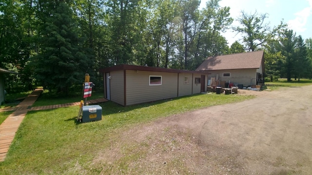 7047 Kingfisher Ln NE, Frohn Twp, MN 56601 - rear view of property with an outdoor structure and a lawn