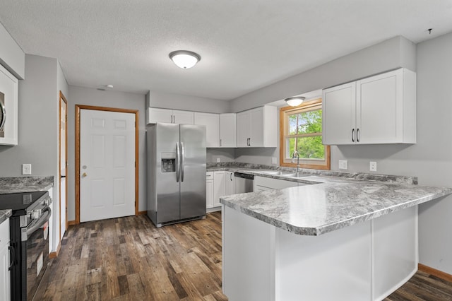 15429 Ramsey Blvd NW, Ramsey, MN 55303 - kitchen featuring stainless steel appliances, a peninsula, a sink, dark wood-style floors, and white cabinets