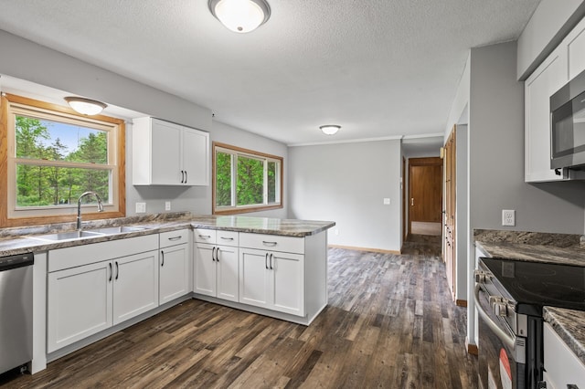 15429 Ramsey Blvd NW, Ramsey, MN 55303 - kitchen with a sink, stainless steel appliances, dark wood-type flooring, a peninsula, and white cabinets