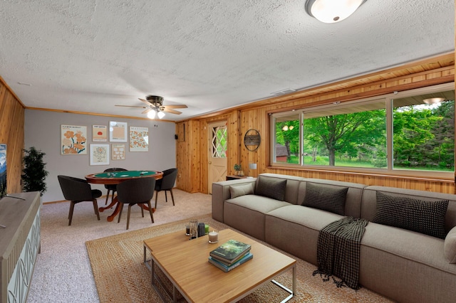 15429 Ramsey Blvd NW, Ramsey, MN 55303 - living area featuring a textured ceiling, wooden walls, a ceiling fan, light carpet, and ornamental molding