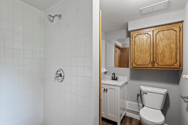 15429 Ramsey Blvd NW, Ramsey, MN 55303 - bathroom featuring vanity, toilet, a tile shower, and wood finished floors