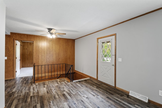 15429 Ramsey Blvd NW, Ramsey, MN 55303 - foyer entrance with a ceiling fan, wooden walls, ornamental molding, wood finished floors, and baseboards