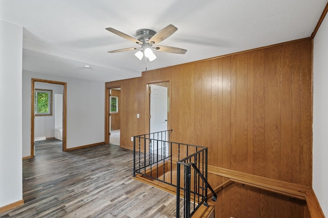 15429 Ramsey Blvd NW, Ramsey, MN 55303 - unfurnished room featuring ceiling fan, baseboards, wood finished floors, and wooden walls
