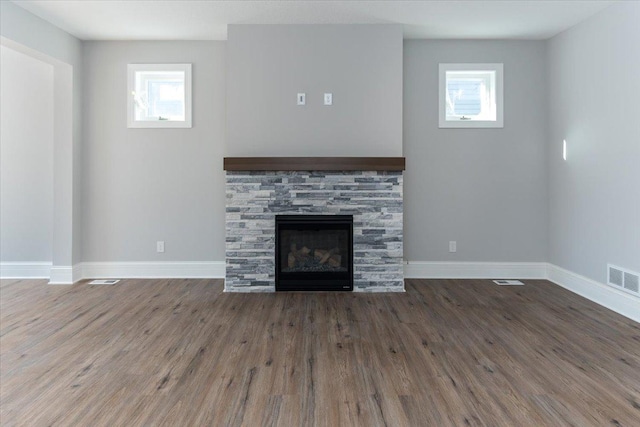 7830 Adler Trl, Inver Grove Heights, MN 55077 - unfurnished living room featuring baseboards, wood finished floors, and a fireplace
