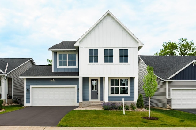 7830 Adler Trl, Inver Grove Heights, MN 55077 - view of front of home with board and batten siding, asphalt driveway, a front yard, a shingled roof, and covered porch