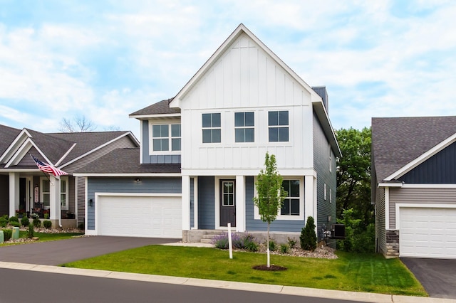 7830 Adler Trl, Inver Grove Heights, MN 55077 - view of front of house featuring board and batten siding, a porch, asphalt driveway, and a front yard
