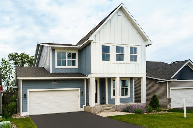 7830 Adler Trl, Inver Grove Heights, MN 55077 - view of front facade featuring covered porch, board and batten siding, driveway, a shingled roof, and a front lawn