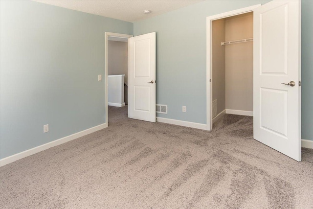 7830 Adler Trl, Inver Grove Heights, MN 55077 - unfurnished bedroom featuring carpet flooring, a walk in closet, baseboards, and a closet