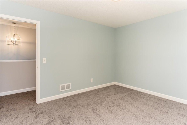 7830 Adler Trl, Inver Grove Heights, MN 55077 - empty room with carpet flooring, a chandelier, and baseboards