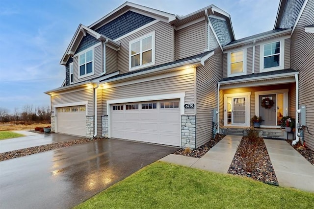 6775 Bluestem Way, Minnetrista, MN 55331 - view of front of home featuring a garage, asphalt driveway, and stone siding