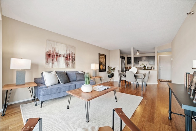 26 10th St W Unit 706, Saint Paul, MN 55102 - living area featuring light wood-type flooring, a ceiling fan, and baseboards