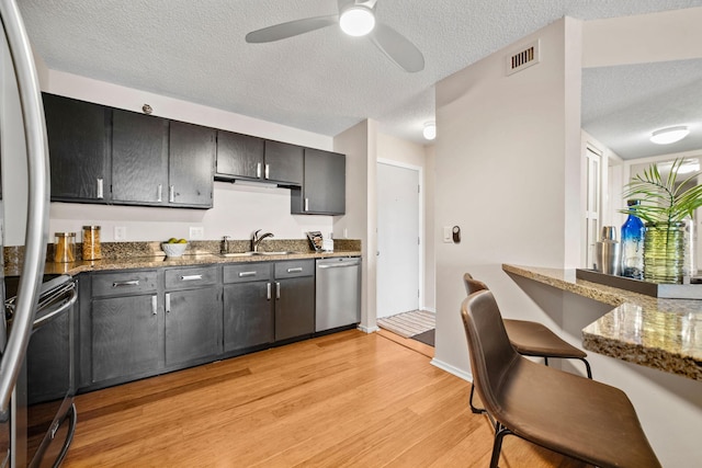 26 10th St W Unit 706, Saint Paul, MN 55102 - kitchen featuring stainless steel dishwasher, black electric range, a textured ceiling, light wood finished floors, and a sink
