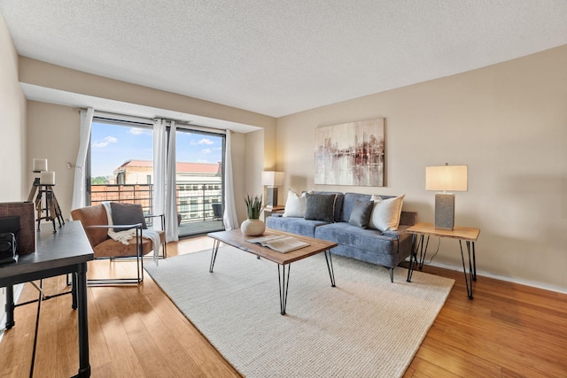 26 10th St W Unit 706, Saint Paul, MN 55102 - living area with light wood-type flooring, a textured ceiling, and baseboards