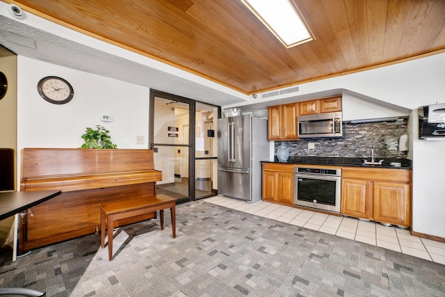 26 10th St W Unit 706, Saint Paul, MN 55102 - kitchen with appliances with stainless steel finishes, light tile patterned flooring, dark countertops, decorative backsplash, and wood ceiling