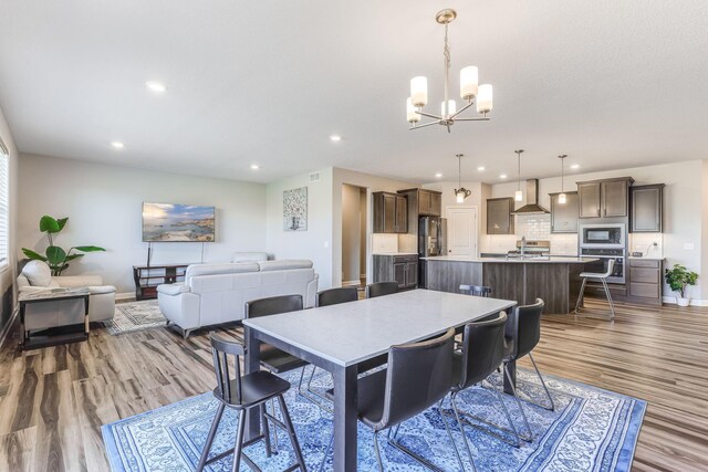 6944 Xanthus Ln N, Maple Grove, MN 55311 - dining room with a chandelier, wood finished floors, recessed lighting, and baseboards
