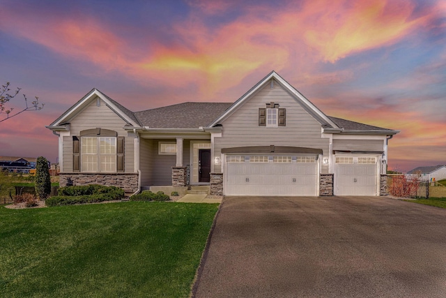 6944 Xanthus Ln N, Maple Grove, MN 55311 - view of front of property featuring stone siding, asphalt driveway, a yard, and a porch