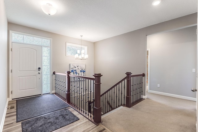 6944 Xanthus Ln N, Maple Grove, MN 55311 - entryway with baseboards, a chandelier, and wood finished floors