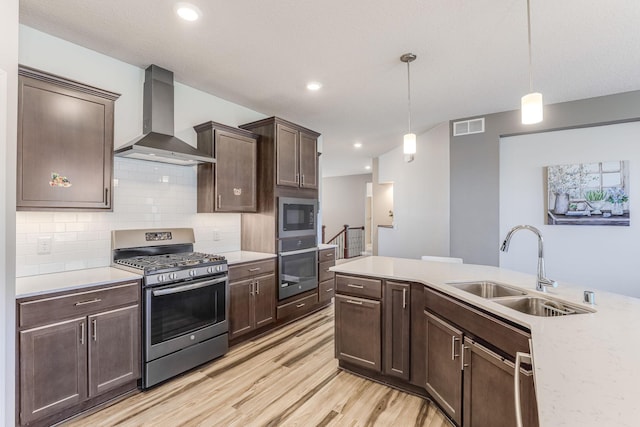 6944 Xanthus Ln N, Maple Grove, MN 55311 - kitchen featuring appliances with stainless steel finishes, wall chimney range hood, a sink, light countertops, and recessed lighting