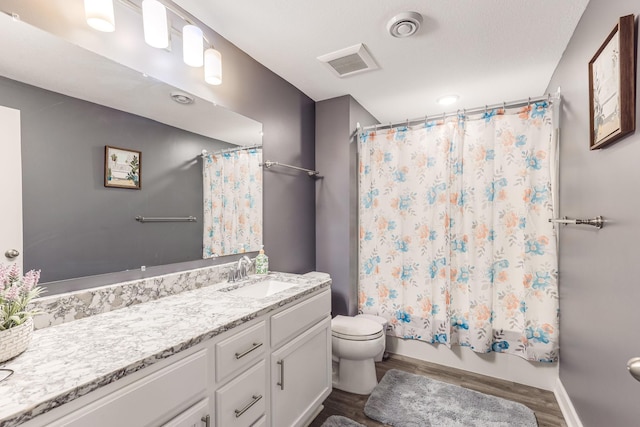 6944 Xanthus Ln N, Maple Grove, MN 55311 - bathroom with toilet, vanity, wood finished floors, shower / tub combo, and baseboards