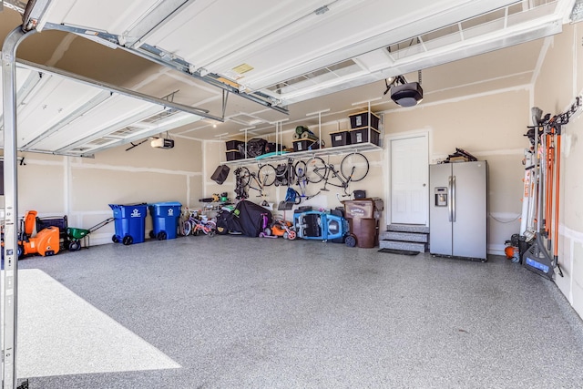 6944 Xanthus Ln N, Maple Grove, MN 55311 - garage with stainless steel fridge and a garage door opener