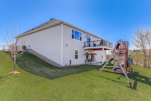 6944 Xanthus Ln N, Maple Grove, MN 55311 - back of house featuring a playground, a wooden deck, and a patio area