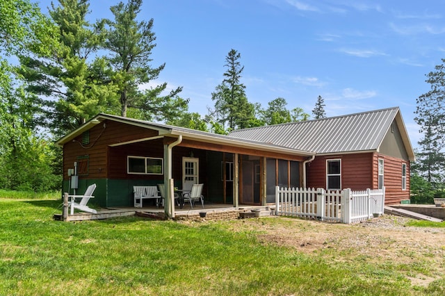 9672 Twain Dr SW, Bemidji, MN 56601 - back of house with a lawn, a patio, metal roof, and a sunroom