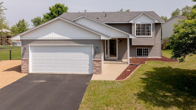 217 Hickory Ln E, Shakopee, MN 55379 - tri-level home featuring asphalt driveway, roof with shingles, and an attached garage
