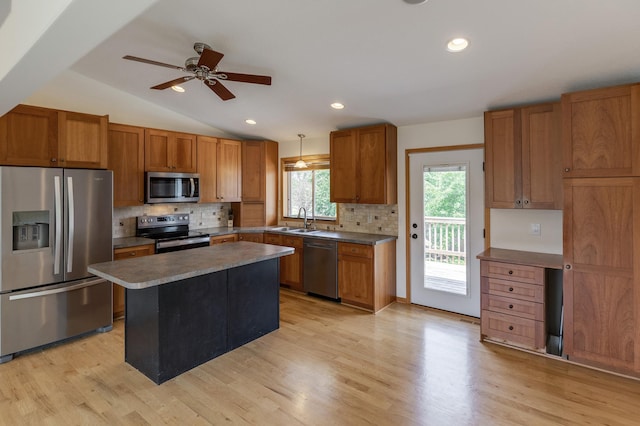 217 Hickory Ln E, Shakopee, MN 55379 - kitchen with stainless steel appliances, a sink, brown cabinetry, decorative backsplash, and ceiling fan