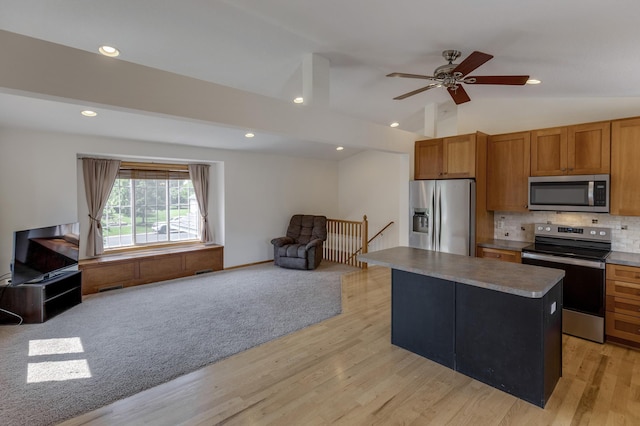217 Hickory Ln E, Shakopee, MN 55379 - kitchen featuring appliances with stainless steel finishes, open floor plan, light wood-style flooring, brown cabinetry, and backsplash