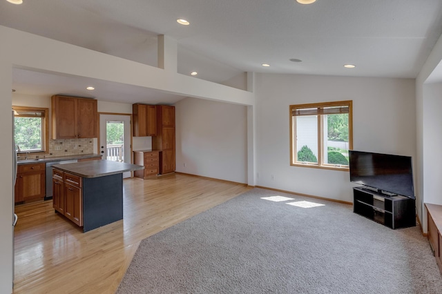 217 Hickory Ln E, Shakopee, MN 55379 - kitchen with stainless steel dishwasher, vaulted ceiling, decorative backsplash, a center island, and recessed lighting