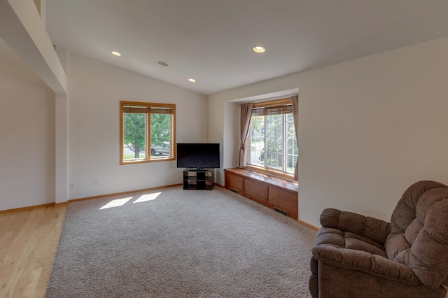217 Hickory Ln E, Shakopee, MN 55379 - living area featuring recessed lighting, baseboards, lofted ceiling, light wood finished floors, and light carpet