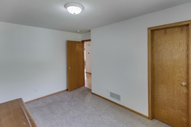 217 Hickory Ln E, Shakopee, MN 55379 - unfurnished bedroom with carpet flooring, a textured ceiling, and baseboards