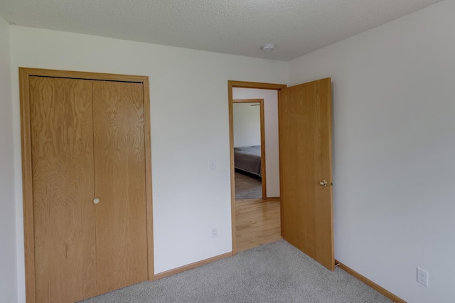 217 Hickory Ln E, Shakopee, MN 55379 - unfurnished bedroom with carpet flooring, baseboards, and a closet