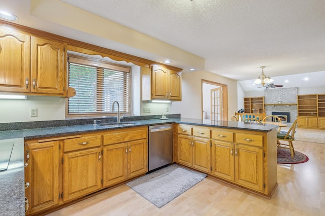 3049 12th St NW, New Brighton, MN 55112 - kitchen with dishwasher, a sink, a peninsula, light wood-style floors, and brown cabinets