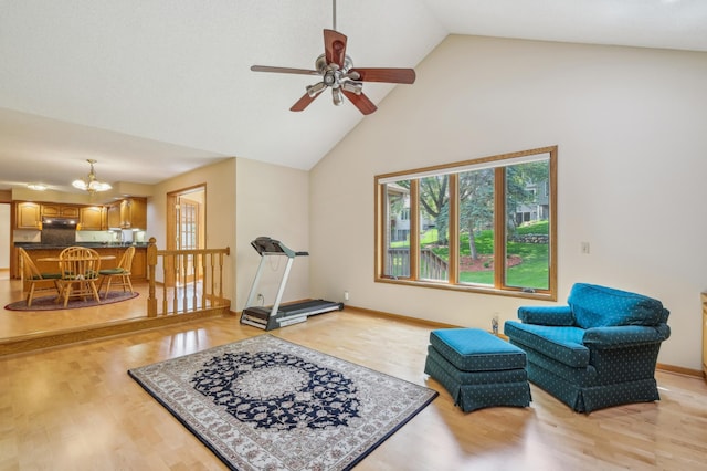 3049 12th St NW, New Brighton, MN 55112 - living area with high vaulted ceiling, light wood finished floors, a chandelier, and a ceiling fan