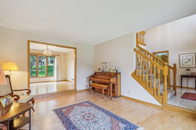 3049 12th St NW, New Brighton, MN 55112 - entryway with wood finished floors, stairs, baseboards, and a chandelier