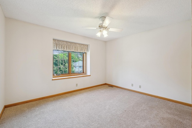 3049 12th St NW, New Brighton, MN 55112 - carpeted spare room featuring baseboards, a textured ceiling, and ceiling fan