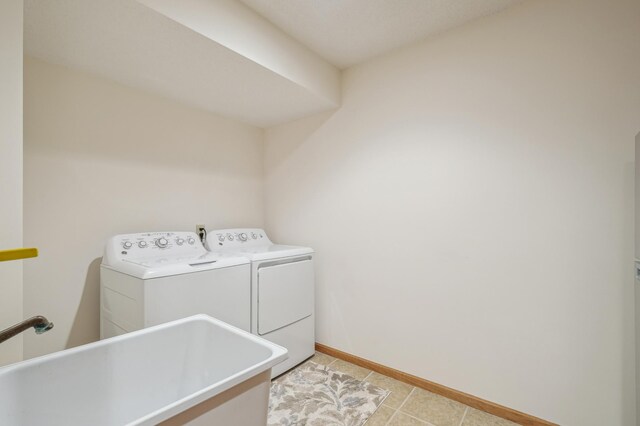 3049 12th St NW, New Brighton, MN 55112 - laundry room featuring separate washer and dryer, baseboards, and light tile patterned flooring