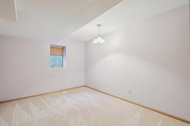 3049 12th St NW, New Brighton, MN 55112 - empty room with light colored carpet, baseboards, a textured ceiling, and a chandelier