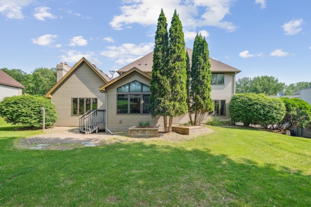 3049 12th St NW, New Brighton, MN 55112 - back of property featuring a yard and a patio area