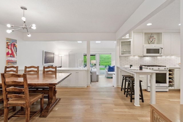 6050 Blake Ridge Rd, Edina, MN 55436 - dining room with light wood finished floors, a chandelier, and recessed lighting