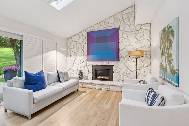 6050 Blake Ridge Rd, Edina, MN 55436 - living room featuring a fireplace, wood finished floors, vaulted ceiling, and a skylight