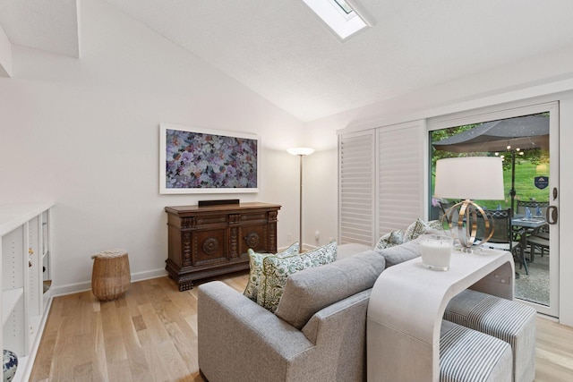 6050 Blake Ridge Rd, Edina, MN 55436 - living room featuring vaulted ceiling, light wood-style floors, and a skylight