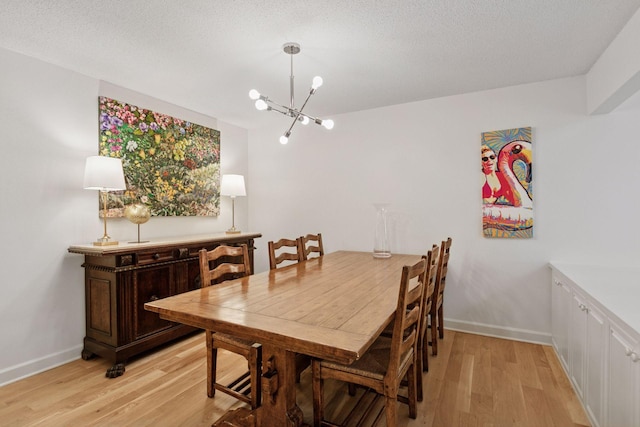 6050 Blake Ridge Rd, Edina, MN 55436 - dining area featuring light wood-style floors and a chandelier