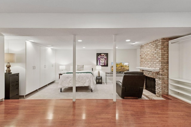 6050 Blake Ridge Rd, Edina, MN 55436 - bedroom featuring wood finished floors, a fireplace, and recessed lighting